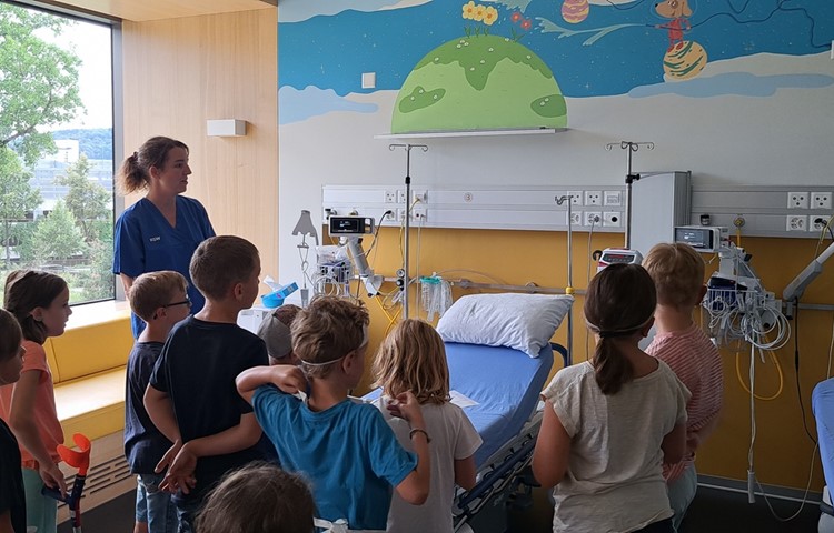 Pflegefachfrau Christa Boulos zeigt den Schülerinnen und Schülern ein Zimmer auf der Kinderstation und erklärt, welche Geräte es hier gibt. Pflegefachfrau Christa Boulos zeigt den Schülerinnen und Schülern ein Zimmer auf der Kinderstation und erklärt, welche Geräte es hier gibt.